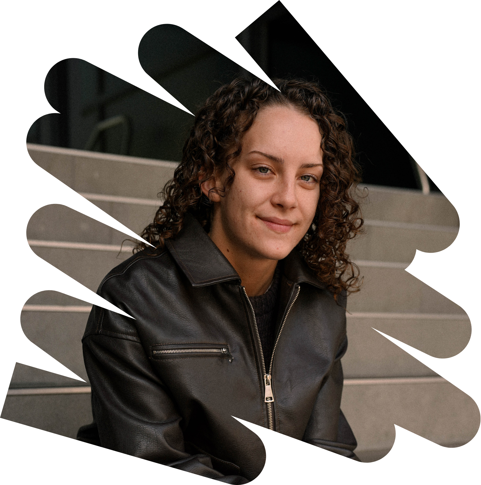 Young woman sitting on steps smiling at the camera