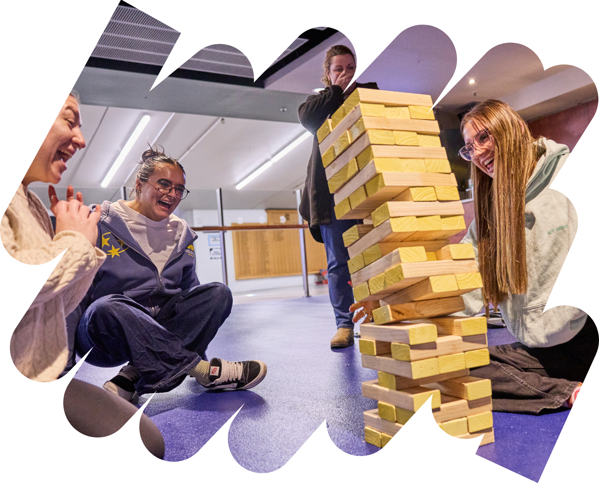 4 women playing giant jenga