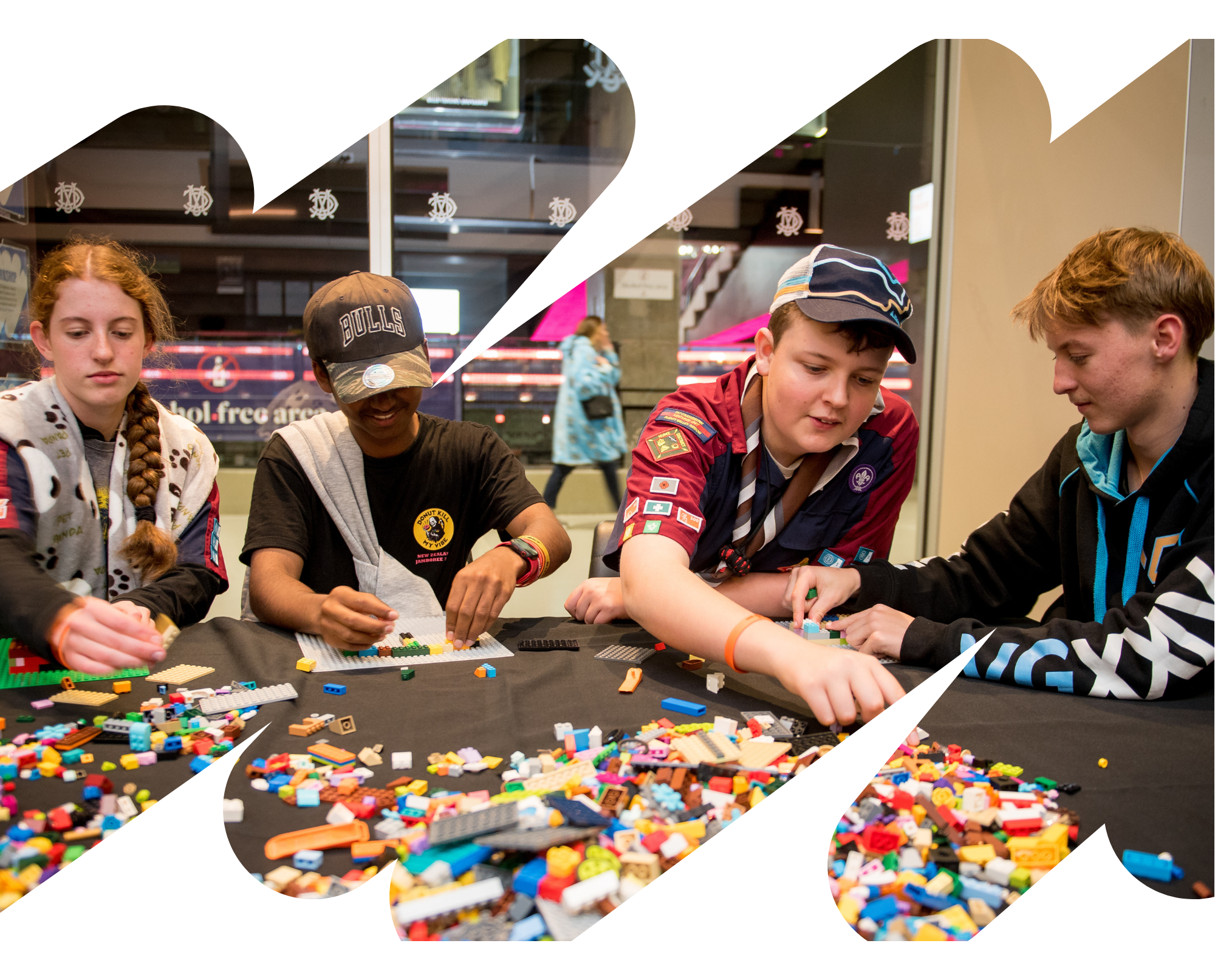 teenagers at a table building lego